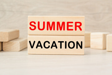 SUMMER VACATION words on the wooden cubes on a bright background