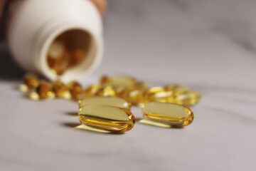 Large yellow jelly pills. Omega 3 vitamins, fish oil, vitamin D. Food additives, dietary supplements