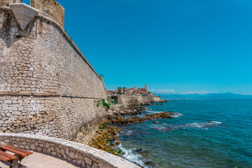 Fototapeta na wymiar Fortress and a staircase made from stones, going into the sea. Many big and small rocks and sea waves hitting the rocks. Blue sea waves background and sky beautiful landscape.