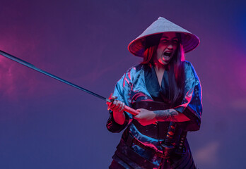 Screaming woman samurai in fight pose with katana