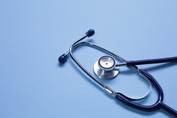 Blue medical stethoscope isolated on blue background