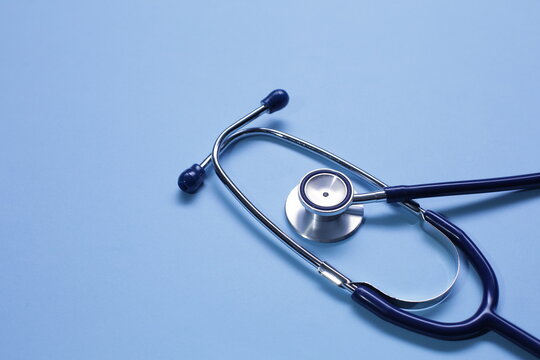 Blue medical stethoscope isolated on blue background