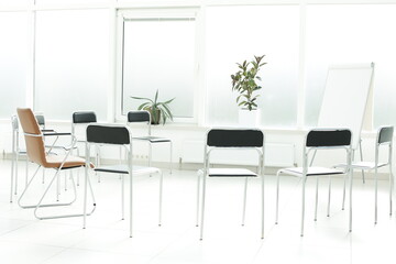 Flipchart and chairs in a bright office space