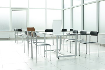 Flipchart chairs and glass table in a bright office space