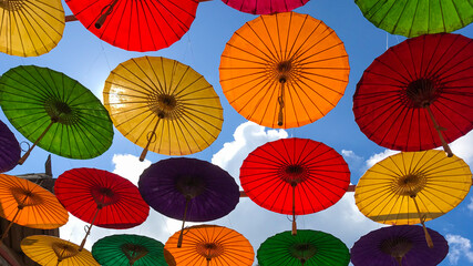 Fototapeta na wymiar Colored umbrellas hung above street