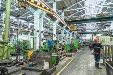 Industrial interior of metalworking factory. Workshop with many machine tools for metal processing, grinding, drilling and cutting. Heavy industry.