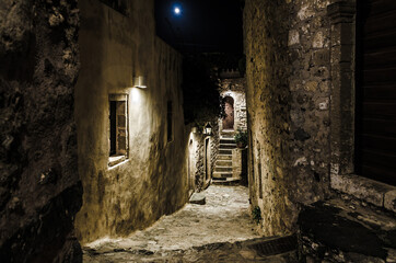 Beautiful Alley in Medieval Castle Town of Monemvasia Island, Greece at Night. Picturesque Street with Stone Houses from Byzantine Era. Sepia Style.