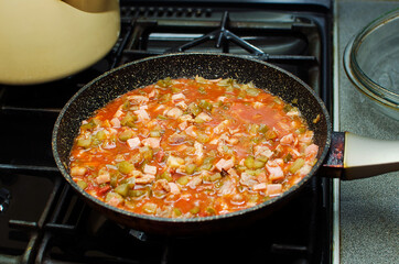 Cooking food in a frying pan.