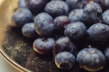 Closeup on fresh and ripe blueberries on a white background