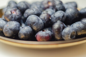Closeup on fresh and ripe blueberries on a white background