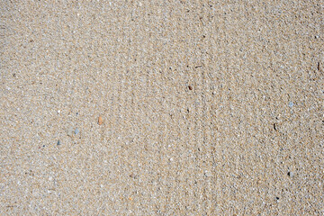 Small pebbles and sand leveled, background texture, top view.