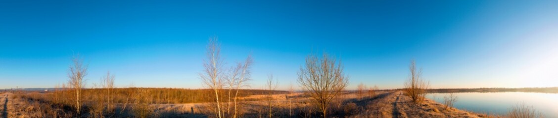 Early spring on a beautiful lake. Blue sky, cloudless and clear.