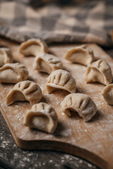 Frozen, beautifully sculpted dumplings laid out on a cutting board