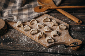 Frozen, beautifully sculpted dumplings laid out on a cutting board