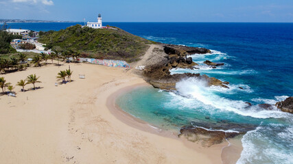 Aerial view of the lonely beach of Poza del Obispo and Arecibo Lighthouse and Historical Park...