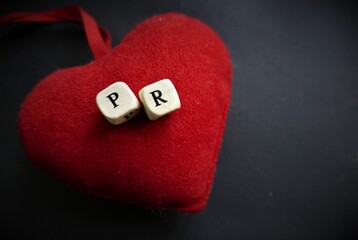 Public relations with heart on dark background