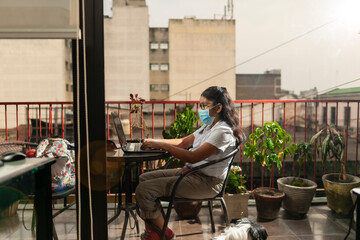 Guatemalan girl doing homework at home while quarantining of epidemic coronavirus.