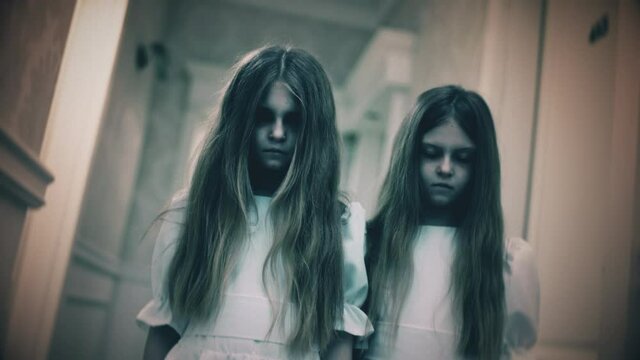 Two creepy little girls with pale faces and blank eyes looking at camera, horror. Paranormal events, ghost activity, horror scene