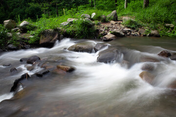 Long exposure water flow and some rocks in the water