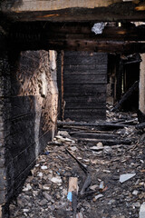 Fototapeta na wymiar Dark burnt wooden house corridor after fire