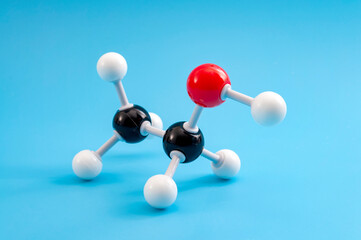 Molecular structure of chemical compounds and organic chemistry concept with educational plastic model of ethanol molecule isolated on blue background - obrazy, fototapety, plakaty
