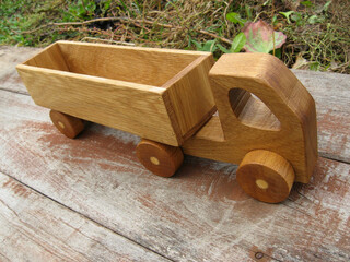 Wooden toy truck on a natural background