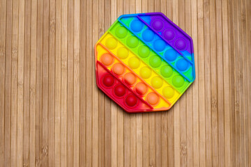 Anti-stress silicone toy on a wooden background.