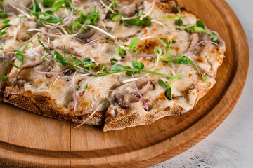 Pinsa romana with octopus seafood, cheese, microgreen. Italian gourmet cuisine. Scrocchiarella.