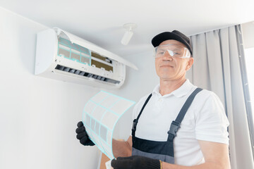 Worker man instal ac conditioner from home or office, maintenance of air conditioning units