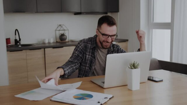I am winner. Young happy surprised businessman , looking at laptop screen and rejoicing his success. business and freelancing