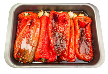 Appetizing home-roasted red peppers on a roasting pan. Tray isolated on white background.