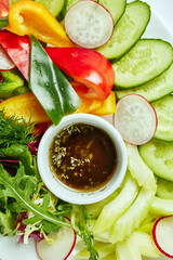 plate with snacks from vegetables on a light background