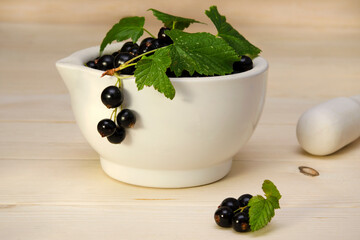 berries black currant in a ceramic bowl close-up