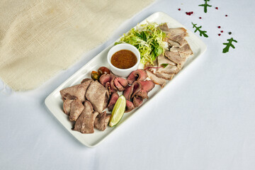 plate of cold cuts appetizers on a light background