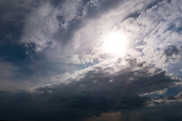 Beautiful fluffy rain clouds in the blue  dramatic sky. Bad weather.