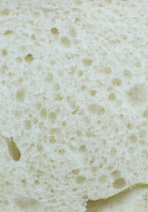 Loaf of white bread inside texture background. Bakery concept. Close up, macro photo.
