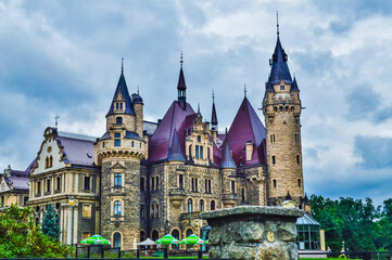 Obraz premium MOSZNA, POLAND, 24 AUGUST 2018: The beautiful Moszna Castle under the clouds