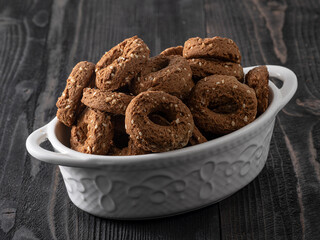 cereal biscuit cookies on a wooden table. oatmeal hard rigid cereal donuts in bowl