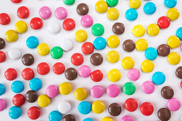 round colored candies on a white background.