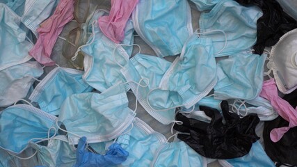 COVID-19 Waste Pollution crisis. Used discarded disposable face masks and latex gloves that have ended up in oceans, in a landfill during the pandemic