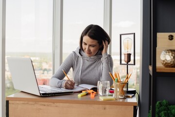 young woman working at laptop in office. High quality photo