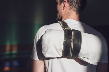Martial arts lifestyle. A man after martial arts training with a kimono behind his back. Place for...