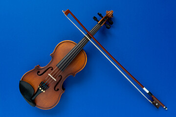 violin and bow on a blue background