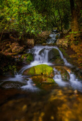 Obraz premium Unnamed waterfall in Ulupinar premium park restaurant. Kemer, Antalya, Turkey. Long exposure picture taken in may 2021