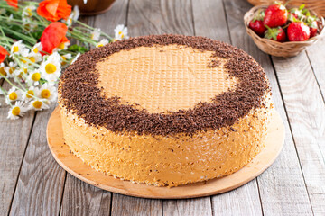 Sweet waffle cake with condensed milk and chocolate on a table