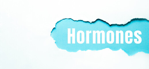 Hormones on torn papper, concept medical background