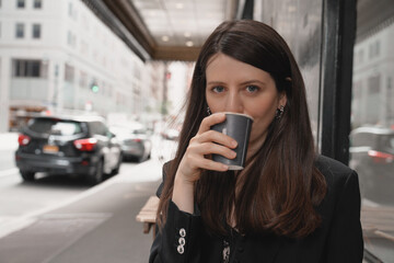 Woman having coffee in plastic cup outdoors