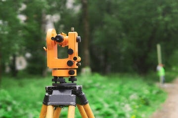modern theodolite during use close-up on blurred background outdoors