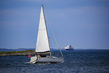 Obraz premium Sailboat with wind in the sails along the Norwegian coastBrønnøysund,Helgeland,Nordland county,Norway,scandinavia,Europe 