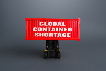 Forklift lifts the container with the inscription Global container shortage. Logistics problems due...